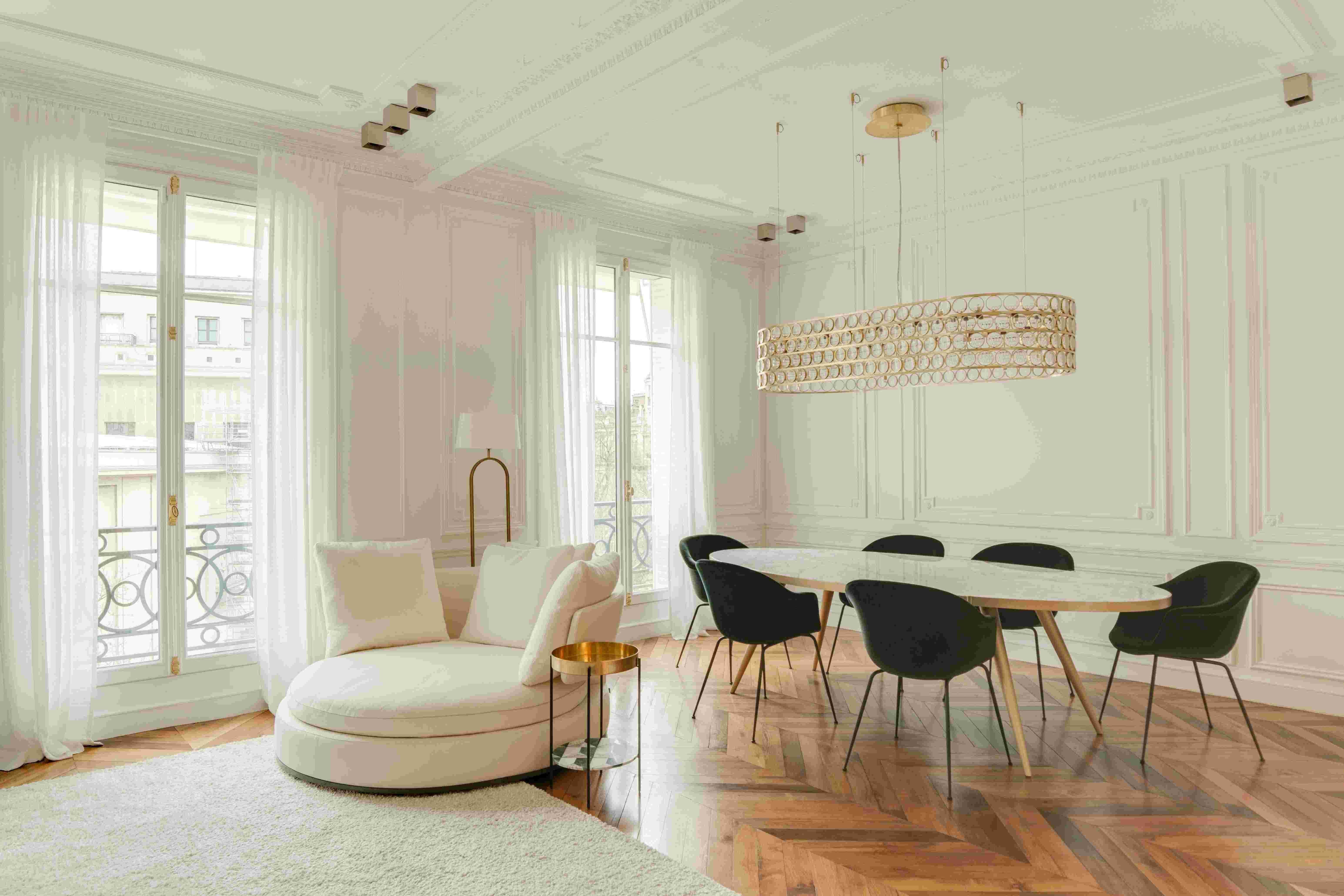 Bright classic apartment interior with chevron wood floors and high-end decor